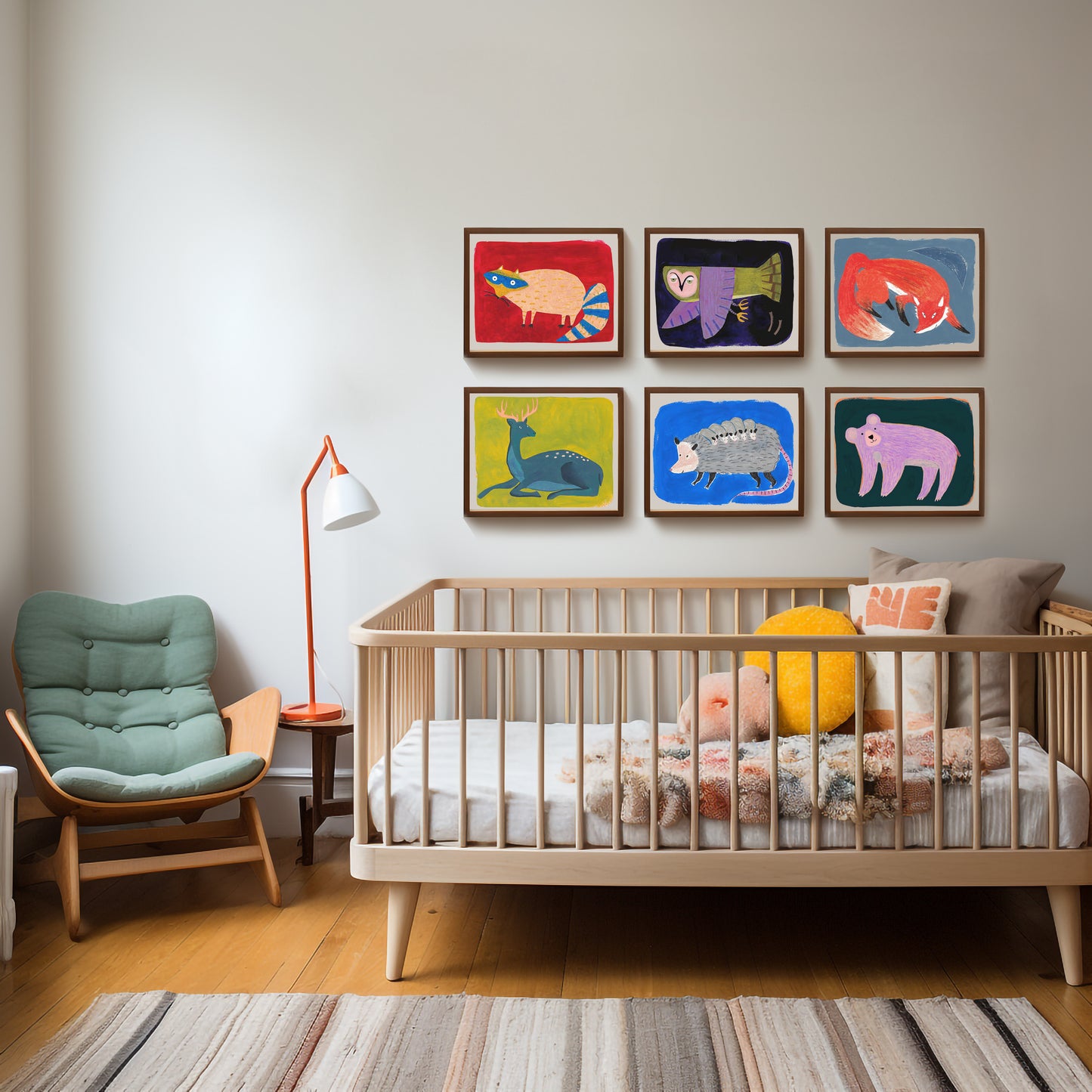 A cozy nursery featuring a crib, colorful animal artwork on the wall, and a comfortable chair.