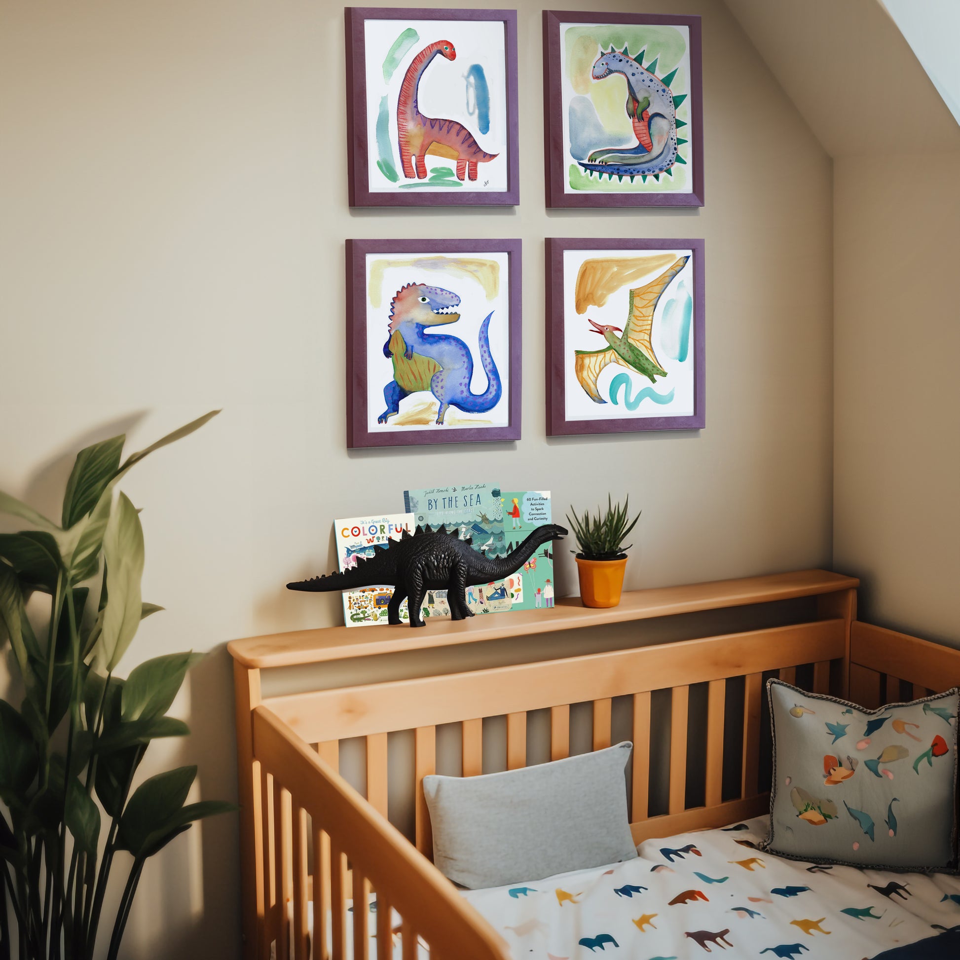 Nursery with dinosaur-themed artwork and plush toys