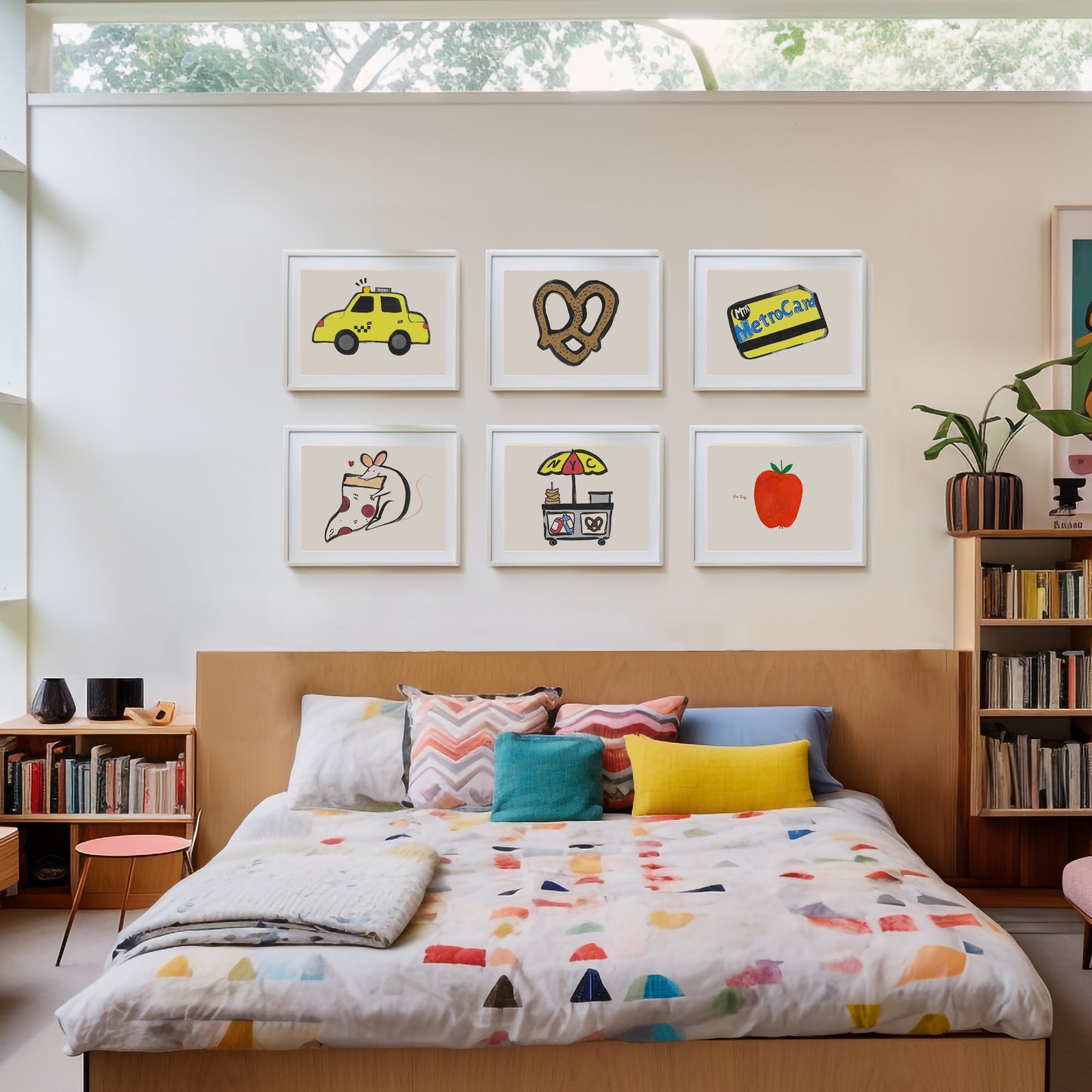 A cozy bedroom featuring a bed with colorful bedding and a gallery wall of framed art.