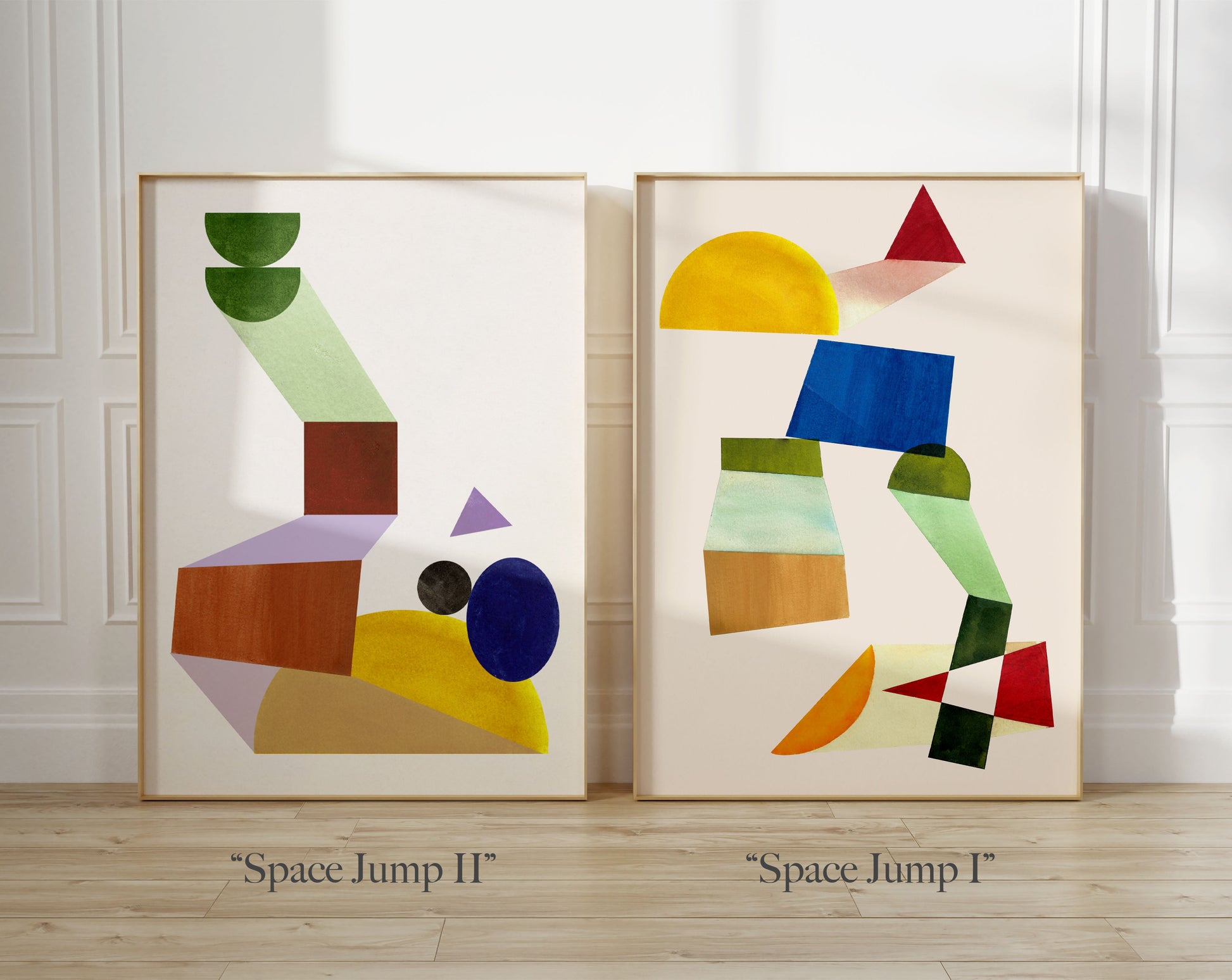 Two framed abstract paintings titled 'Space Jump I' and 'Space Jump II' displayed side by side in a bright room.