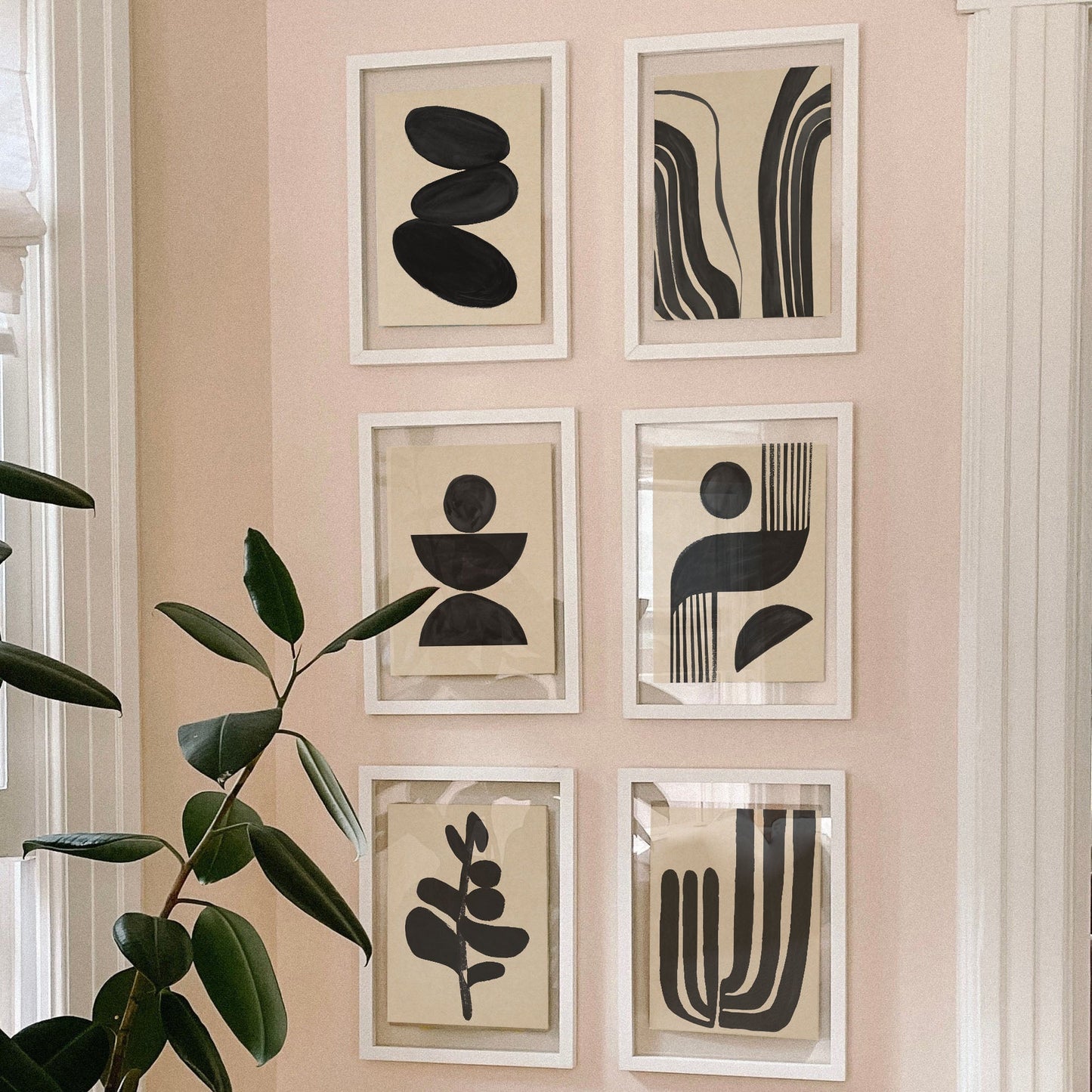 Gallery wall featuring six framed abstract art pieces in black and white.