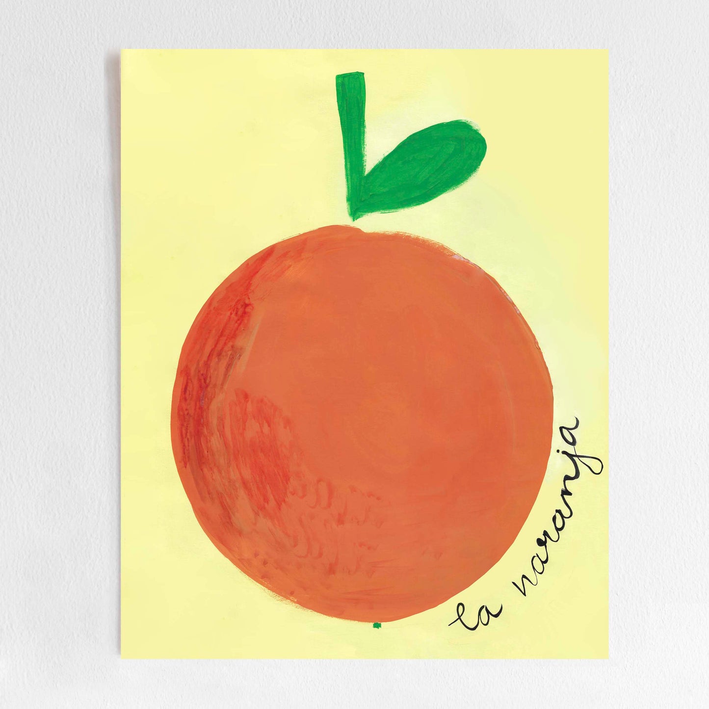 A colorful illustration of an orange with a green leaf on a yellow background, labeled 'la naranja'.
