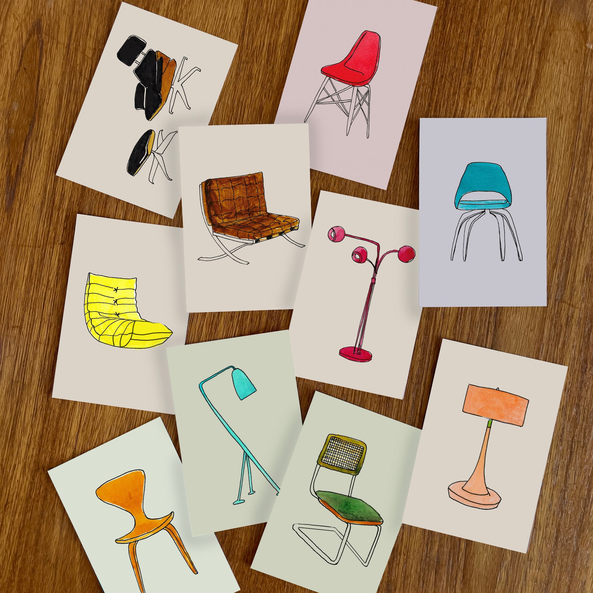 A collection of art illustrations featuring various chairs and lamps on a wooden surface.
