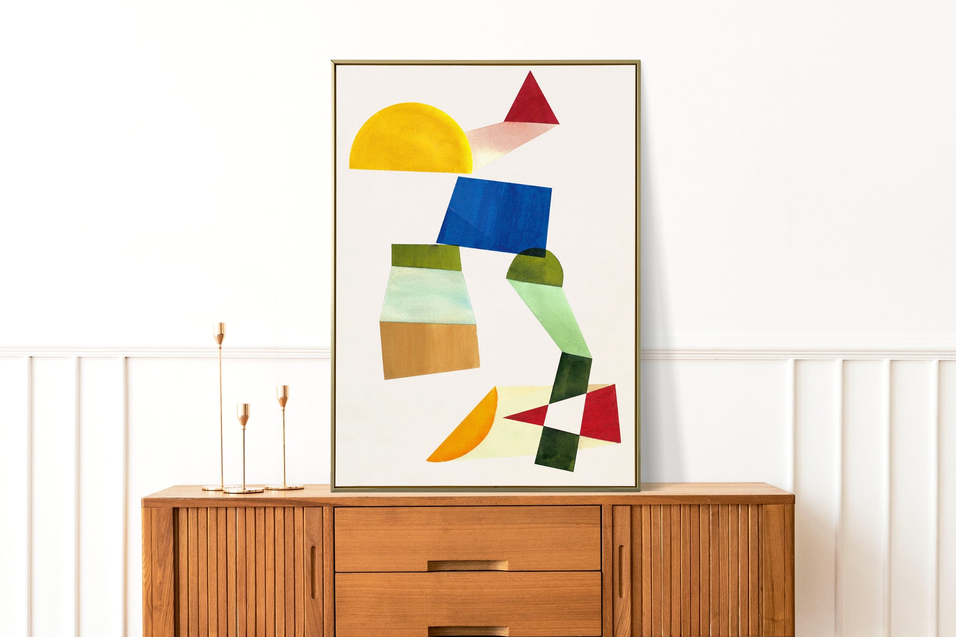 Abstract artwork featuring geometric shapes in various colors displayed on a wooden sideboard.
