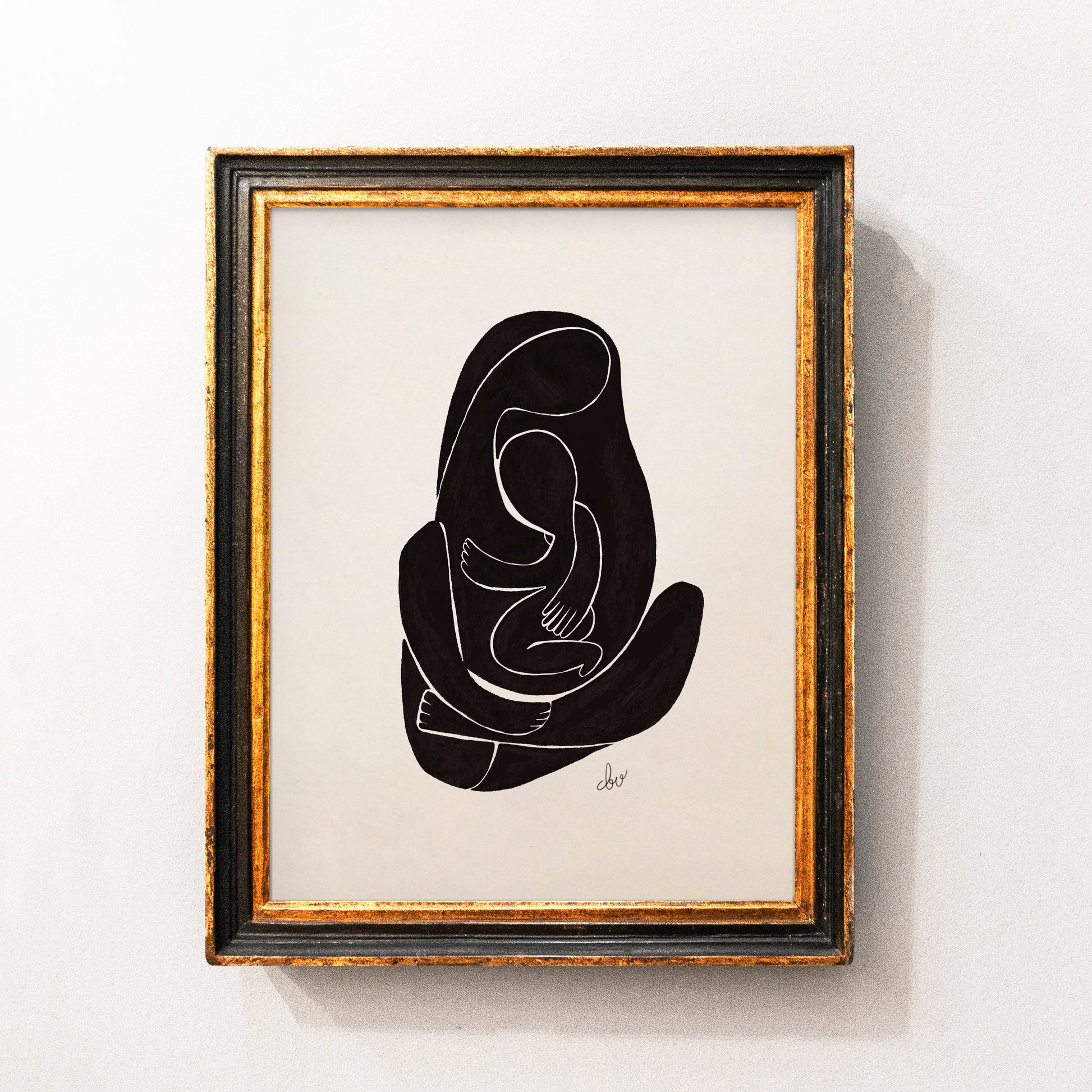 Abstract line drawing of a mother holding a child in a framed artwork