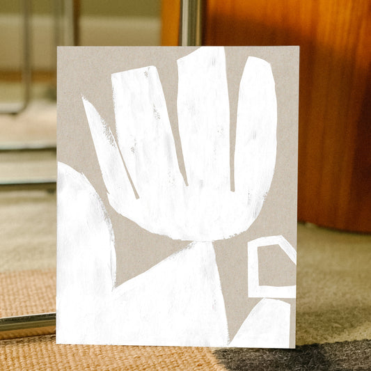 Abstract white artwork on a beige background