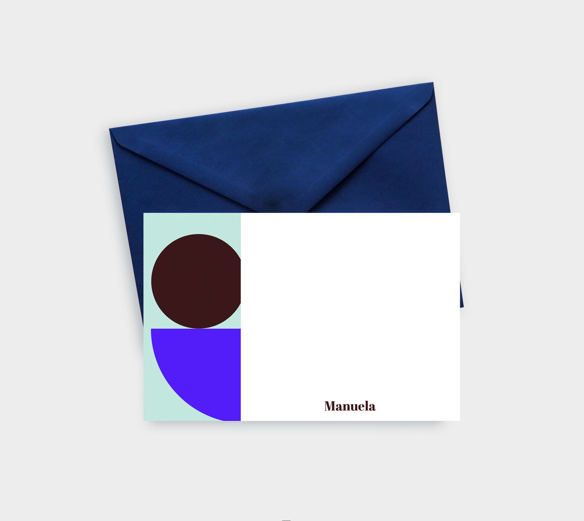 A modern greeting card design featuring abstract shapes in teal, brown, and purple, accompanied by a navy envelope.