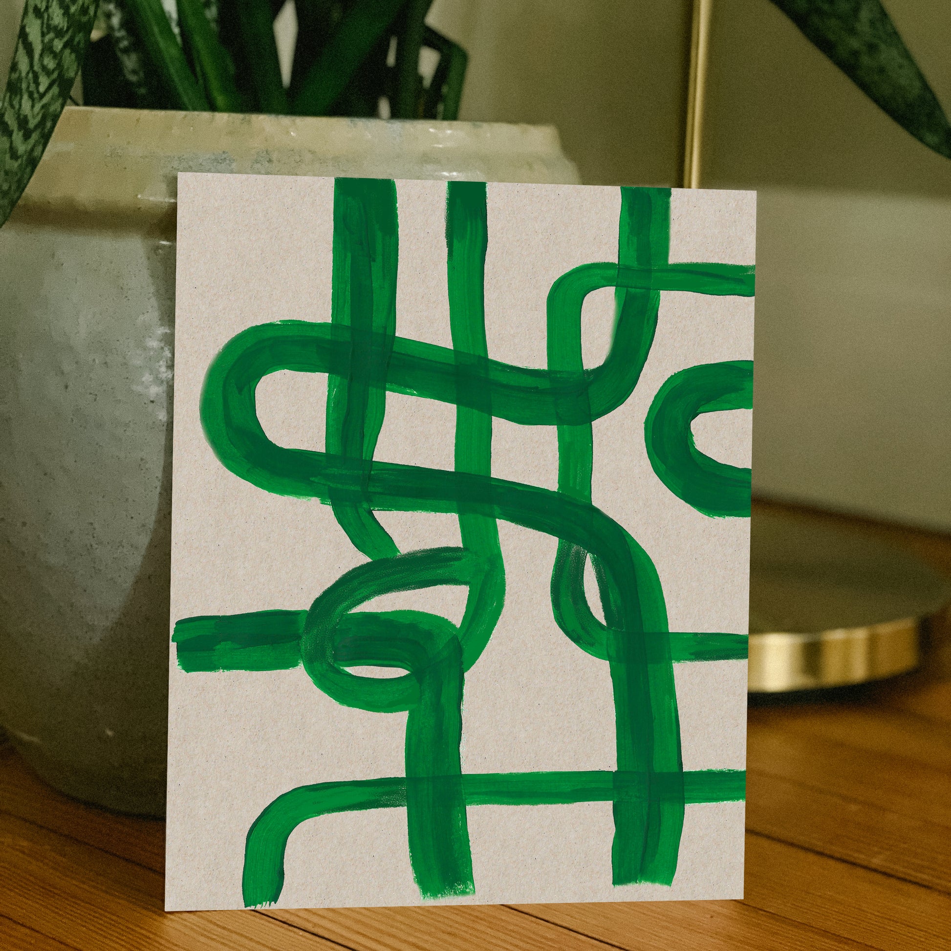 Abstract green line artwork on textured paper.